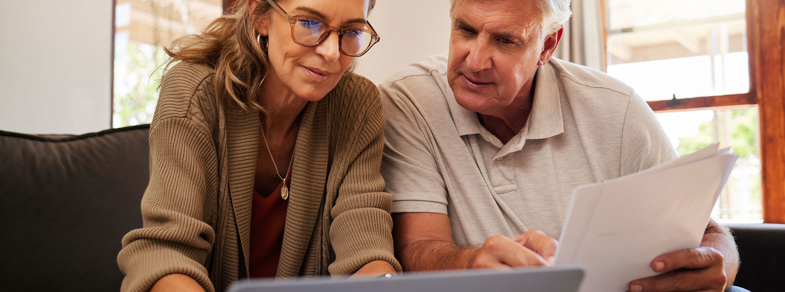 Couple using laptop in living room
